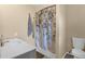 Bathroom with a modern sink, toilet, and shower with a floral shower curtain at 4727 Wales St, Lake Wales, FL 33859