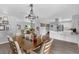 Open dining room with view to kitchen, living room, and contemporary chandelier at 4727 Wales St, Lake Wales, FL 33859