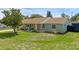 Single-story home features stone accents, a well-manicured lawn, and a welcoming front porch at 4727 Wales St, Lake Wales, FL 33859
