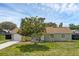 Charming single-story home with a well-maintained lawn, stone accents, and a mature tree in the front yard at 4727 Wales St, Lake Wales, FL 33859
