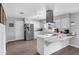 Bright kitchen with white cabinets, stainless steel appliances, hardwood floors, and ample counter space at 4727 Wales St, Lake Wales, FL 33859