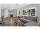 Inviting living room with hardwood floors, a comfortable sofa, and natural light from the large front window at 4727 Wales St, Lake Wales, FL 33859