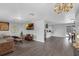 Open-concept living room featuring hardwood floors, modern decor, and seamless flow into the dining area and kitchen at 4727 Wales St, Lake Wales, FL 33859