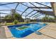 Inviting screened-in pool with a clear blue water and a spacious surrounding deck perfect for outdoor entertaining at 4727 Wales St, Lake Wales, FL 33859