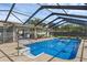 This screened-in pool with a covered patio and grilling area is perfect for outdoor gatherings and relaxation at 4727 Wales St, Lake Wales, FL 33859