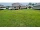 Lush backyard features a large lawn, exterior home view, and a tidy landscape creating a welcoming space at 6354 Sedgeford Dr, Lakeland, FL 33811