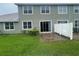 Home exterior showcasing a well-maintained backyard with lawn, patio, and a privacy fence at 6354 Sedgeford Dr, Lakeland, FL 33811