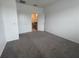 Carpeted bedroom with neutral walls and an ensuite bathroom, creating a calming retreat at 6354 Sedgeford Dr, Lakeland, FL 33811