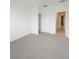 Bright, carpeted bedroom with a closet and view into the hallway through an open door at 6354 Sedgeford Dr, Lakeland, FL 33811