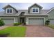 Inviting home showcasing a brick driveway, well-maintained lawn, and an attached two-car garage at 6354 Sedgeford Dr, Lakeland, FL 33811