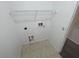 Utility room with tile flooring, featuring hookups, and a wire shelf, ready for appliances at 6354 Sedgeford Dr, Lakeland, FL 33811