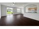 Bright living room with hardwood floors, ceiling fan, and sliding glass doors to the outside at 6354 Sedgeford Dr, Lakeland, FL 33811