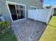 Exterior patio with sliding glass door, partial privacy fence, landscaping and brick pavers at 6354 Sedgeford Dr, Lakeland, FL 33811