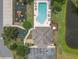 Aerial view of community pool, playground, clubhouse and parking, near a pond at 6523 Evergreen Park Dr, Lakeland, FL 33813