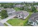Aerial view showcases a well-maintained home in a neighborhood with lush green landscaping and a manicured lawn at 6523 Evergreen Park Dr, Lakeland, FL 33813