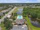 Aerial view of community clubhouse, pool, playground, pond and lush landscaping at 6523 Evergreen Park Dr, Lakeland, FL 33813
