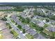Aerial view of a residential neighborhood highlighting houses with verdant lawns and tree-lined streets at 6523 Evergreen Park Dr, Lakeland, FL 33813