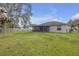 The backyard includes a screened-in patio and is surrounded by a well-maintained lawn and a chain-link fence at 6523 Evergreen Park Dr, Lakeland, FL 33813