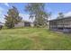 The backyard boasts a spacious screened-in patio and lush green grass at 6523 Evergreen Park Dr, Lakeland, FL 33813