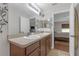 Bathroom featuring double sinks, floral accents, and an open door into a bedroom at 6523 Evergreen Park Dr, Lakeland, FL 33813