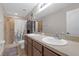 Bathroom featuring a double sink vanity, recessed lights, a shower with a curtain, and neutral decor at 6523 Evergreen Park Dr, Lakeland, FL 33813