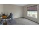 Bedroom featuring neutral walls, carpet flooring, a window with blinds, and a work desk at 6523 Evergreen Park Dr, Lakeland, FL 33813