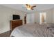 Bedroom featuring hardwood floors, ceiling fan, and an adjacent bathroom, and storage closet at 6523 Evergreen Park Dr, Lakeland, FL 33813