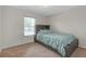 Bright bedroom features a comfortable twin bed, soft carpet, and a sunlit window at 6523 Evergreen Park Dr, Lakeland, FL 33813