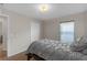 Neutral bedroom with a double bed and neutral bedding, complemented by natural light from the window at 6523 Evergreen Park Dr, Lakeland, FL 33813