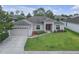 Well-maintained home showcasing a lush green lawn and a charming front entrance at 6523 Evergreen Park Dr, Lakeland, FL 33813