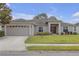 Charming single-story home featuring a well-manicured lawn, attached two car garage, and welcoming front entrance at 6523 Evergreen Park Dr, Lakeland, FL 33813