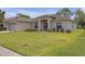 Charming home featuring a well-manicured lawn and a welcoming front entrance at 6523 Evergreen Park Dr, Lakeland, FL 33813