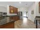 Well-lit kitchen with granite countertops, stainless steel refrigerator, and tiled floors at 6523 Evergreen Park Dr, Lakeland, FL 33813
