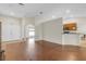 Open-concept living area with hardwood floors, neutral paint, and seamless access to the kitchen at 6523 Evergreen Park Dr, Lakeland, FL 33813