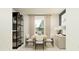 Well-lit dining area with modern table, chairs, stylish hutch and elegant decor at 1181 Hour Glass Rd, Lakeland, FL 33801