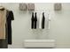 Organized walk-in closet with clothing racks, hanging garments, and storage baskets for a tidy and functional space at 1181 Hour Glass Rd, Lakeland, FL 33801
