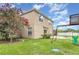Spacious backyard with green grass, a playset, and blossoming crape myrtle tree at 2721 Stonewood Dr, Lakeland, FL 33810