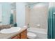 Bathroom featuring tile, a shower-tub combo, a sink, and blue paint at 2721 Stonewood Dr, Lakeland, FL 33810