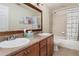 Bathroom featuring double sinks, a large mirror, tile floors, and a shower with a patterned curtain at 2721 Stonewood Dr, Lakeland, FL 33810
