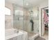 Bathroom featuring a glass-enclosed shower, separate tub, and modern fixtures at 2721 Stonewood Dr, Lakeland, FL 33810