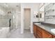 Bright bathroom featuring tiled floors, a glass shower, and double sinks at 2721 Stonewood Dr, Lakeland, FL 33810