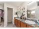 Bathroom featuring double sinks, ample storage, and a door leading to a water closet at 2721 Stonewood Dr, Lakeland, FL 33810