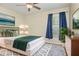 Staged bedroom featuring a bed, a window with curtains, and art pieces at 2721 Stonewood Dr, Lakeland, FL 33810