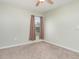 Neutral bedroom featuring a ceiling fan, neutral paint, carpeting, and a bright window at 2721 Stonewood Dr, Lakeland, FL 33810