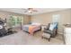 Bright bedroom featuring a ceiling fan, exercise equipment, and a cozy seating area by the window at 2721 Stonewood Dr, Lakeland, FL 33810