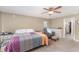 Comfortable bedroom with a ceiling fan, recliner, and access to an en-suite bathroom with a tiled shower at 2721 Stonewood Dr, Lakeland, FL 33810