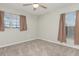 Bedroom featuring a ceiling fan, neutral paint, carpeting, and two bright windows at 2721 Stonewood Dr, Lakeland, FL 33810