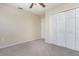 Bedroom featuring a ceiling fan, carpet, and a double door closet at 2721 Stonewood Dr, Lakeland, FL 33810