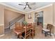 Cozy dining room with a wooden table, chairs, and a view of the staircase and kitchen area at 2721 Stonewood Dr, Lakeland, FL 33810