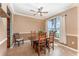 Warm dining room with a wooden table, chairs, and a window overlooking the exterior at 2721 Stonewood Dr, Lakeland, FL 33810